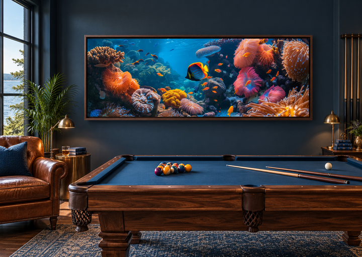 Underwater coral reef narrow horizontal framed canvas wall art above a pool table in a dark room.
