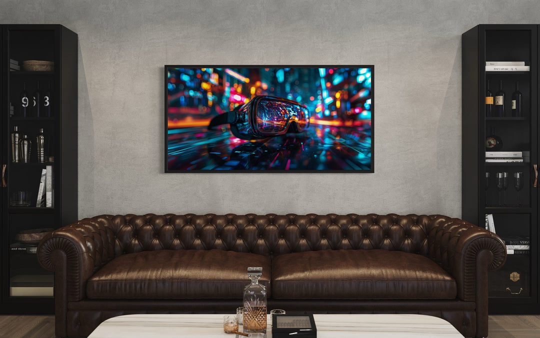 Futuristic VR goggles canvas wall art with neon lights above a brown leather sofa in a game room.