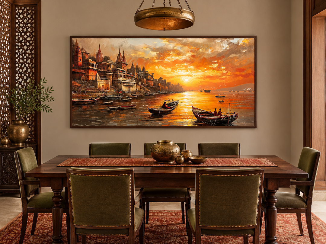 Varanasi wall art of a Ganges River sunset over a dining table in a warm-toned room.