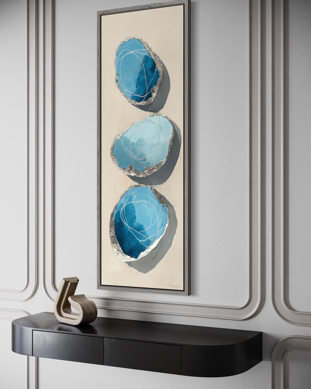 Vertical abstract canvas print featuring three blue and silver stones on a tall, narrow frame.