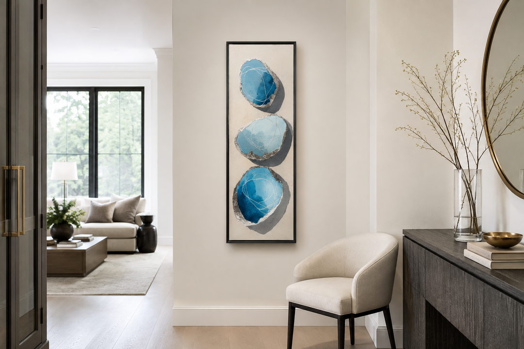 Vertical canvas print with three stacked abstract blue and silver stones on a neutral background.