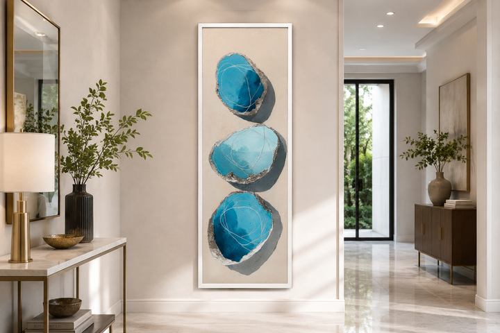 Vertical canvas print with three stacked abstract blue and silver stones on a neutral background.