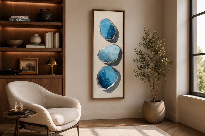 Vertical canvas print with three stacked abstract blue and silver stones on a neutral background.
