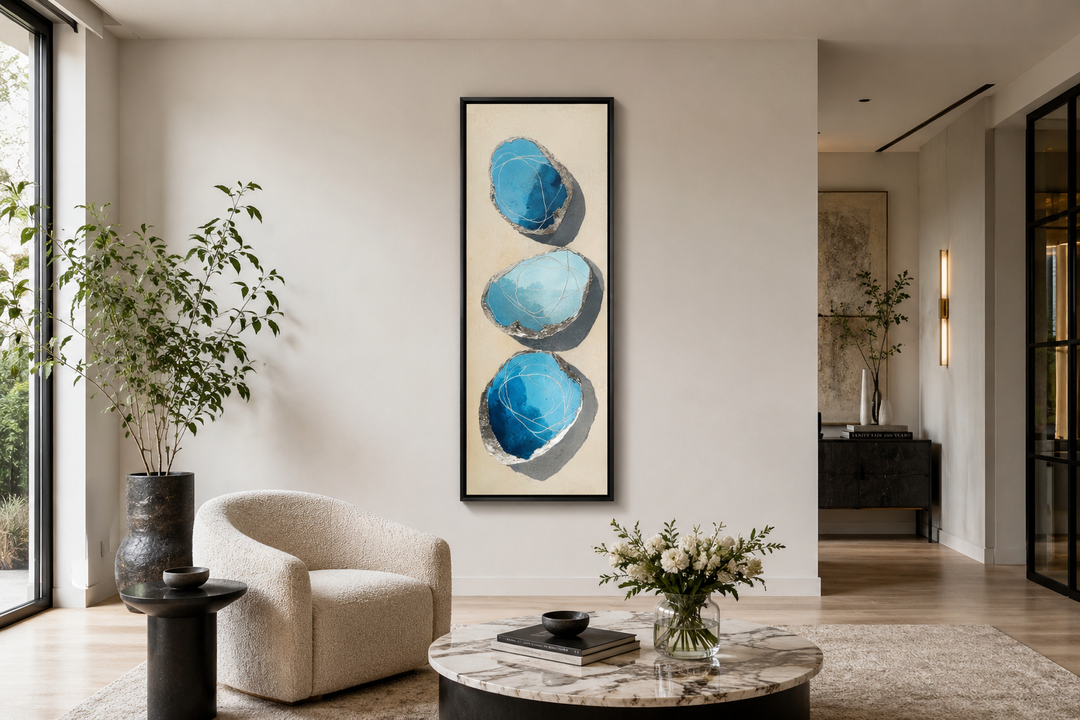 Vertical canvas print of three stacked abstract blue and silver stones on a neutral background.