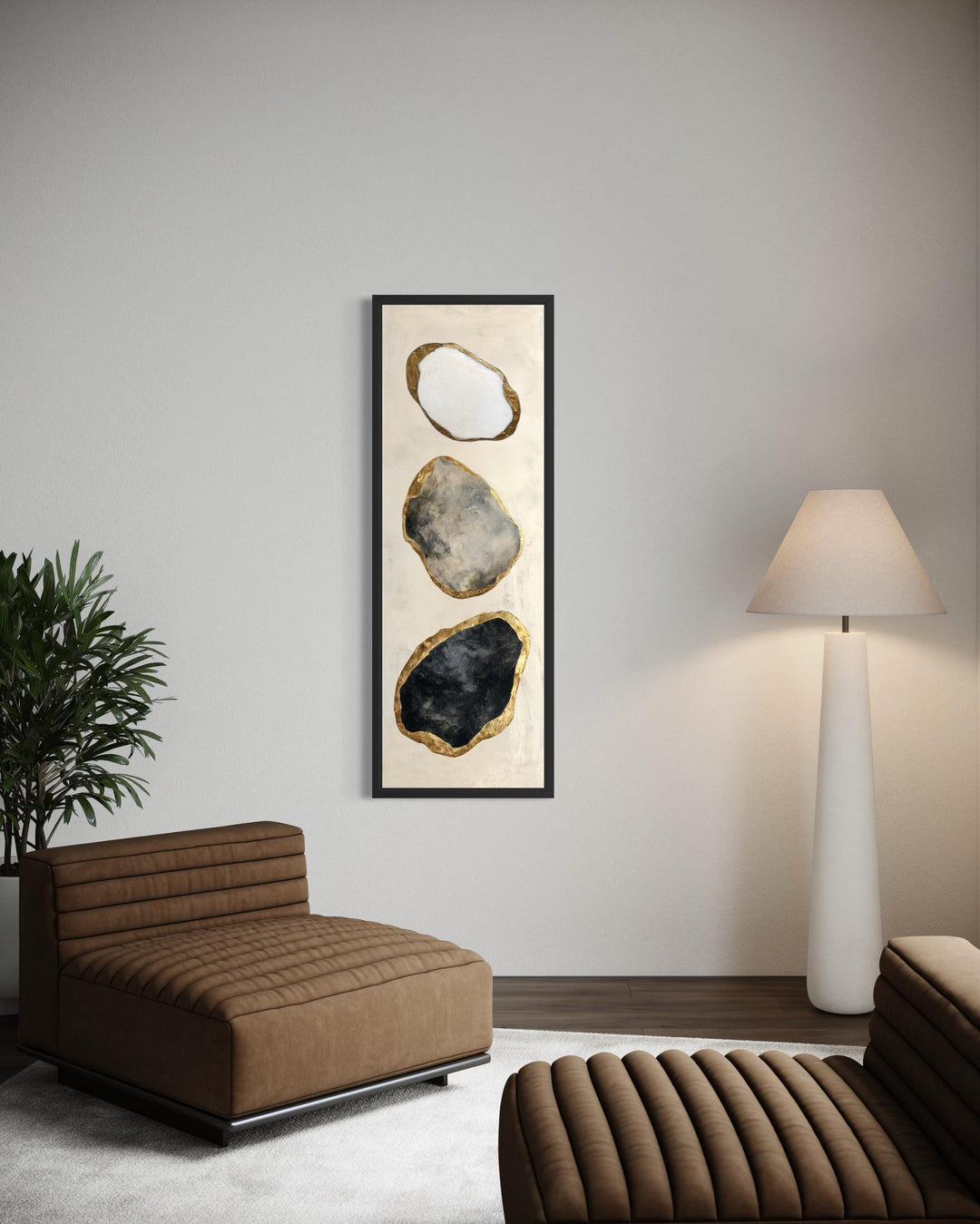 Vertical abstract wall art featuring three stacked rock shapes in white, grey, and black with gold.