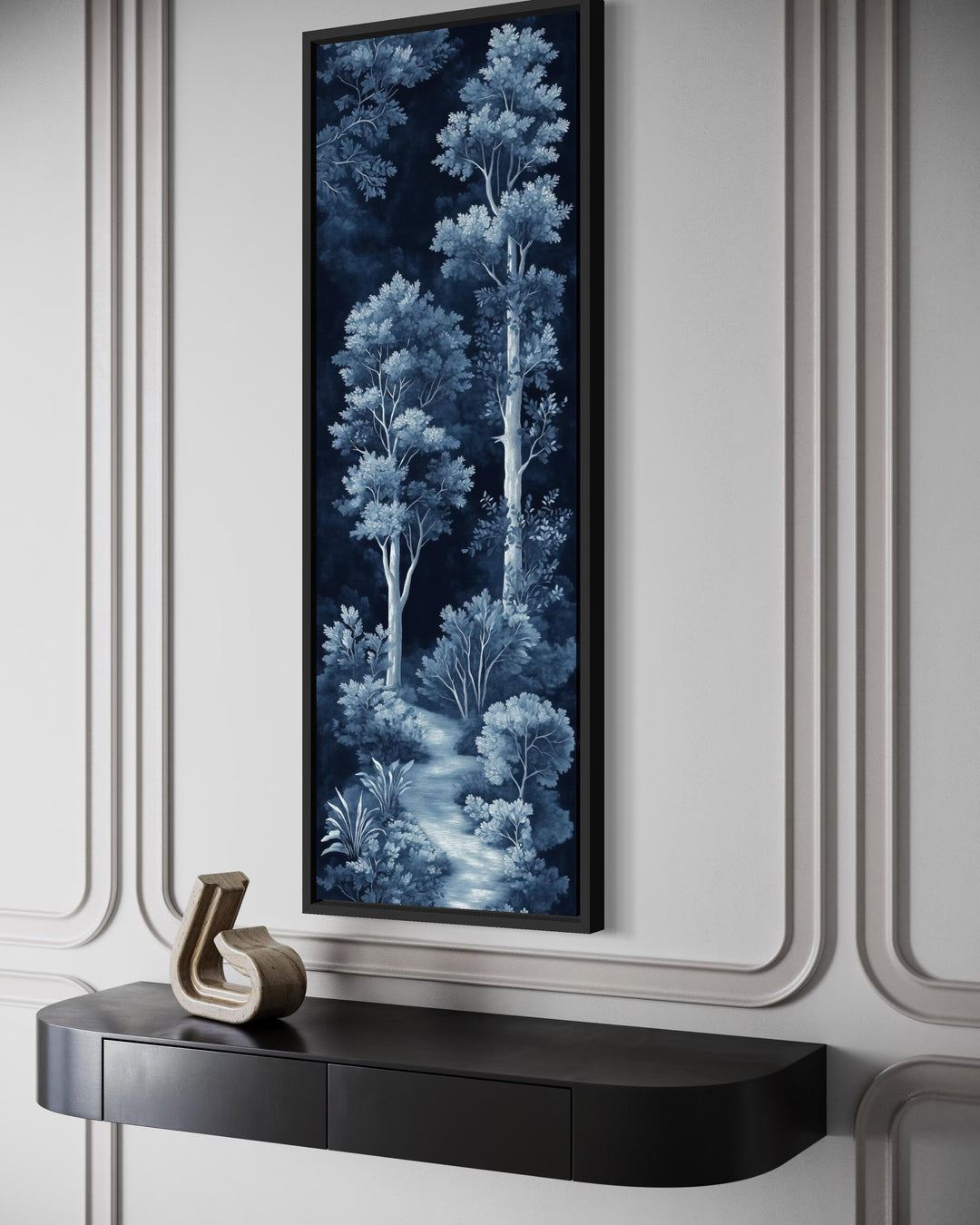 Vertical narrow wall art of a blue and navy night forest scene above a black console table.