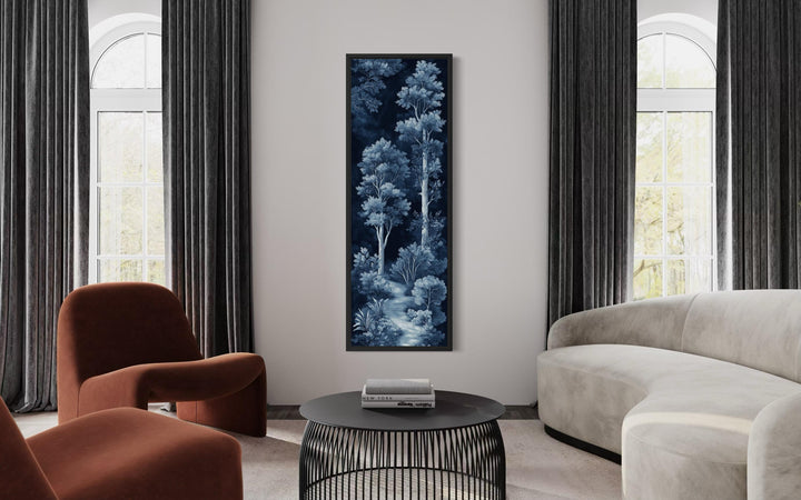 Vertical narrow wall art featuring a blue and navy night forest scene in a modern living room.
