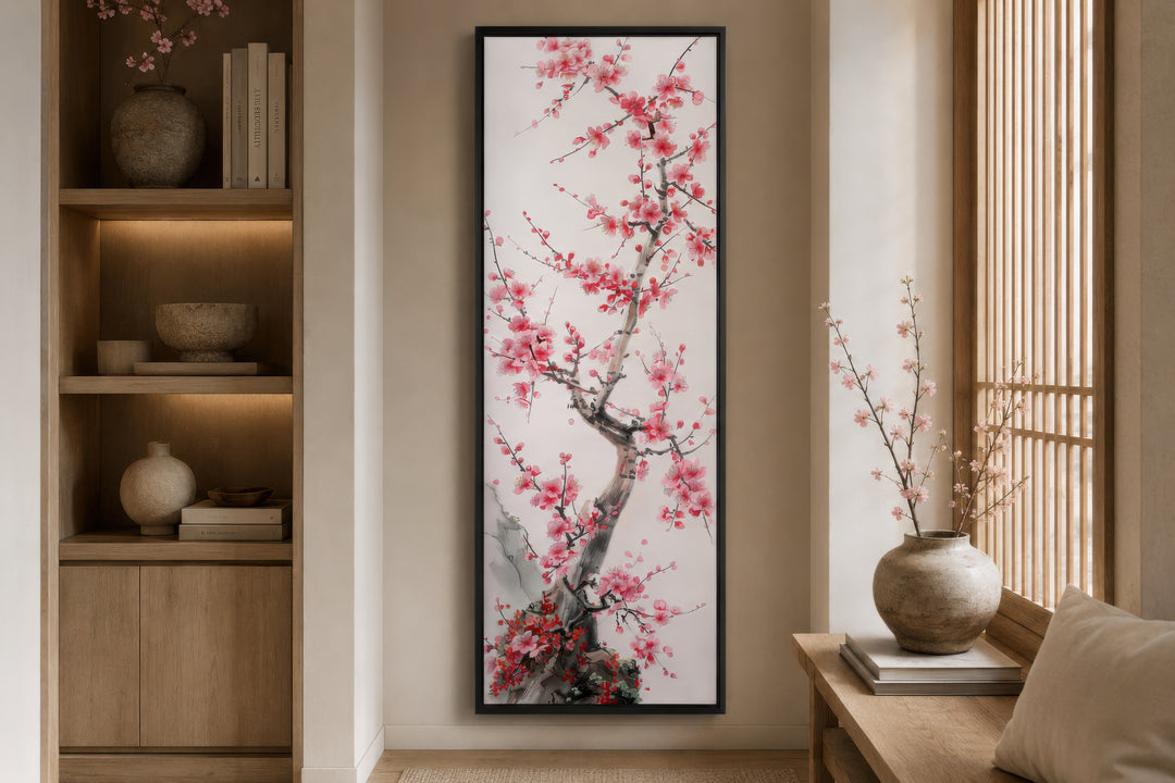 Vertical narrow wall art featuring a cherry blossom tree in a black frame on a neutral wall.