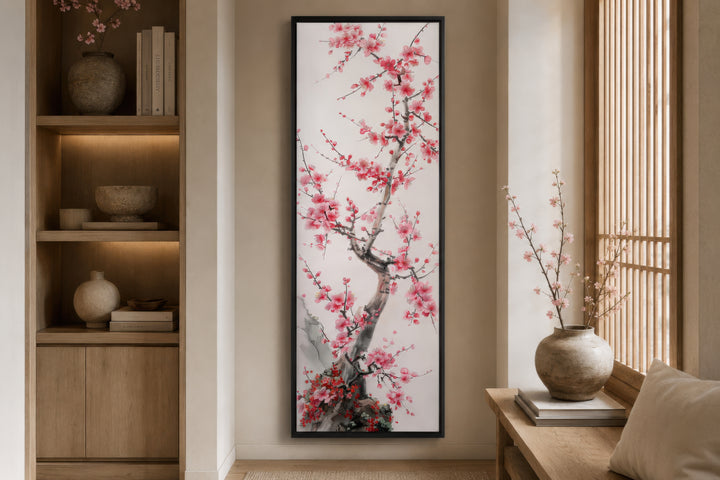Vertical narrow wall art featuring a cherry blossom tree in a black frame on a neutral wall.