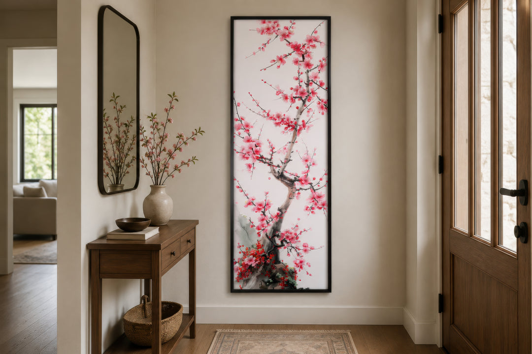 Vertical narrow wall art featuring a cherry blossom tree in a black frame in a home entryway.