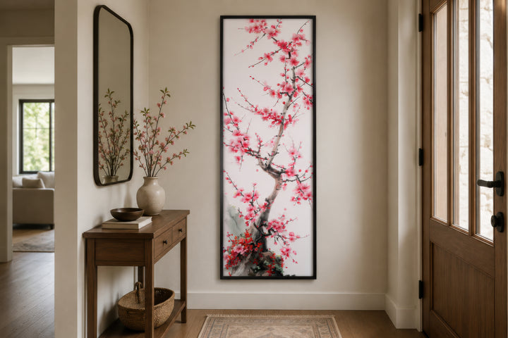 Vertical narrow wall art featuring a cherry blossom tree in a black frame in a home entryway.
