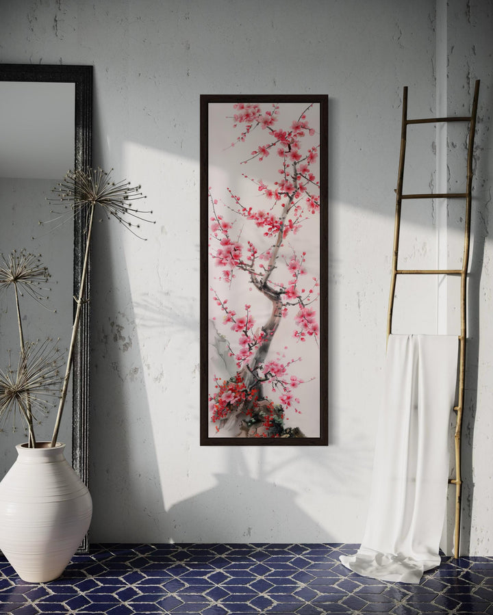 Vertical narrow wall art featuring a cherry blossom tree in a dark frame on a textured wall.