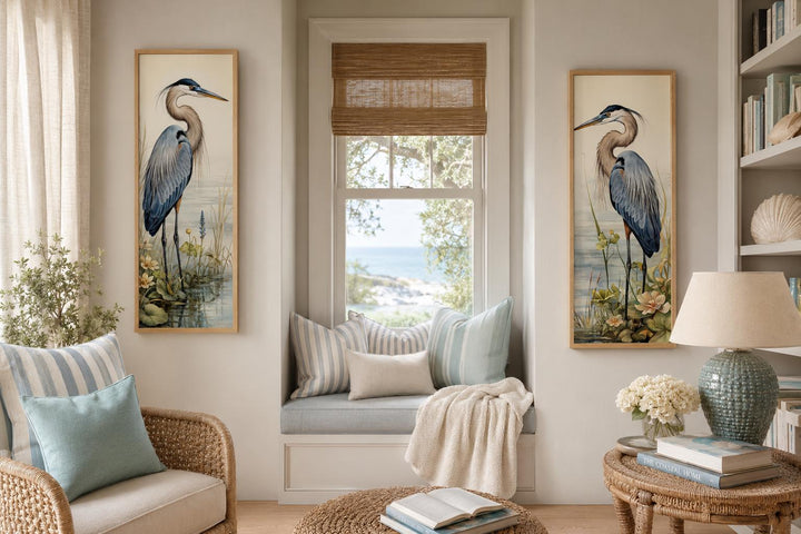 Set of two vertical canvas wall art prints featuring Great Blue Herons in a coastal living room.
