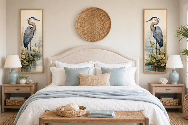 Vertical slim Great Blue Heron canvas wall art set of 2 in a coastal bedroom above nightstands.