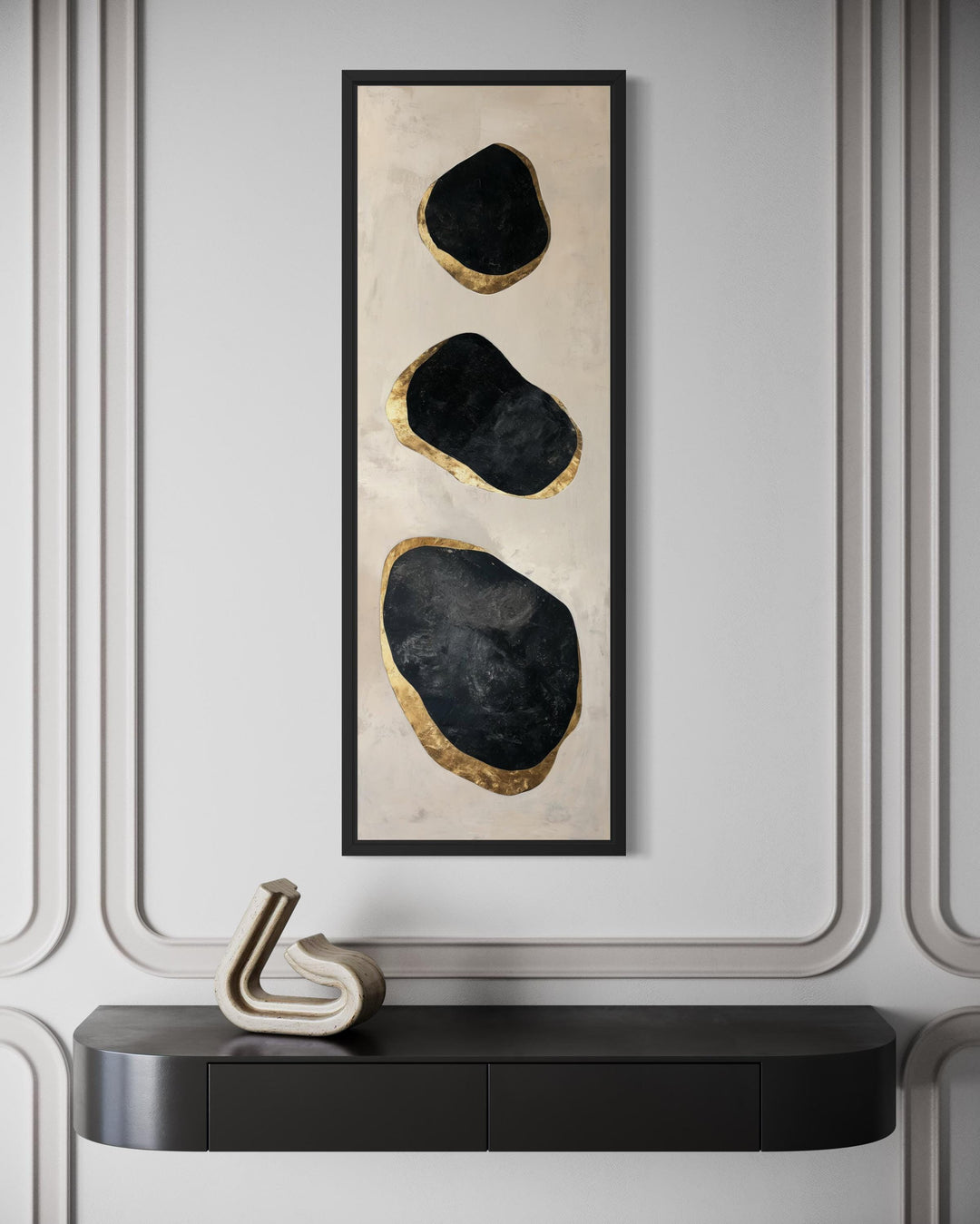 Vertical tall narrow wall art featuring three black and gold abstract rock shapes in a black frame.