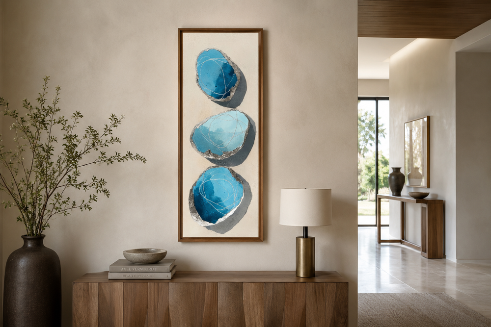Vertical canvas print of three stacked abstract blue and silver stones on a neutral background.
