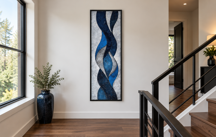 Tall thin vertical navy blue and grey geometric abstract framed canvas wall art in a modern hallway.