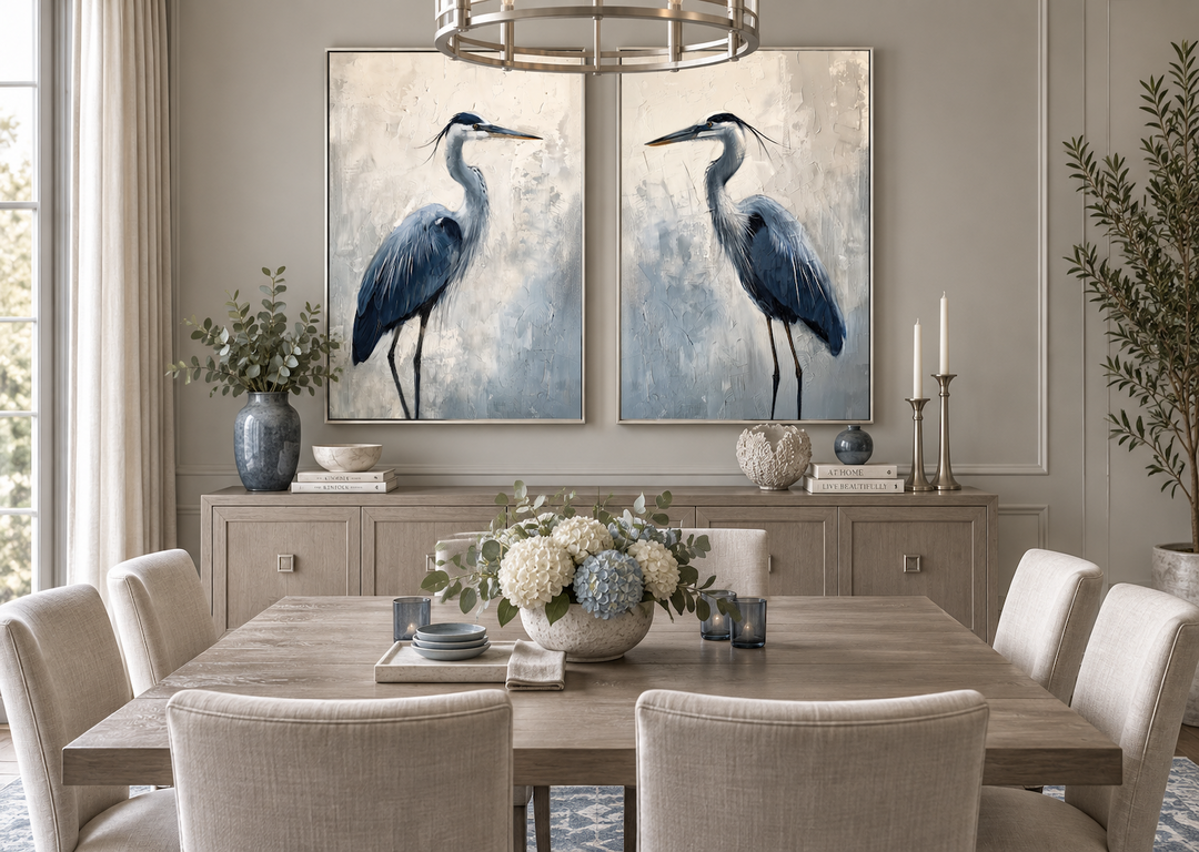 Set of 2 framed canvas prints featuring abstract blue herons in a coastal-themed dining room.
