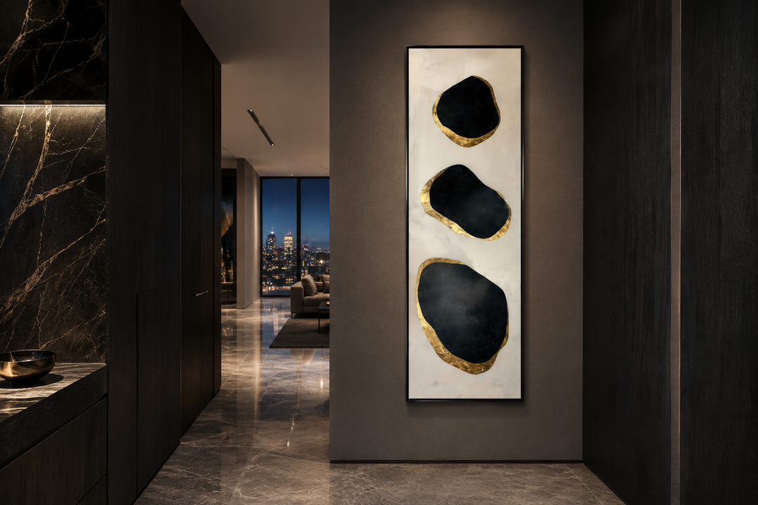 Vertical tall narrow black and gold abstract rocks wall art in a modern entryway.