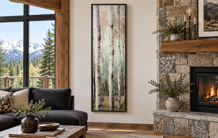 Long narrow vertical watercolor birch trees framed canvas wall art in a rustic living room.