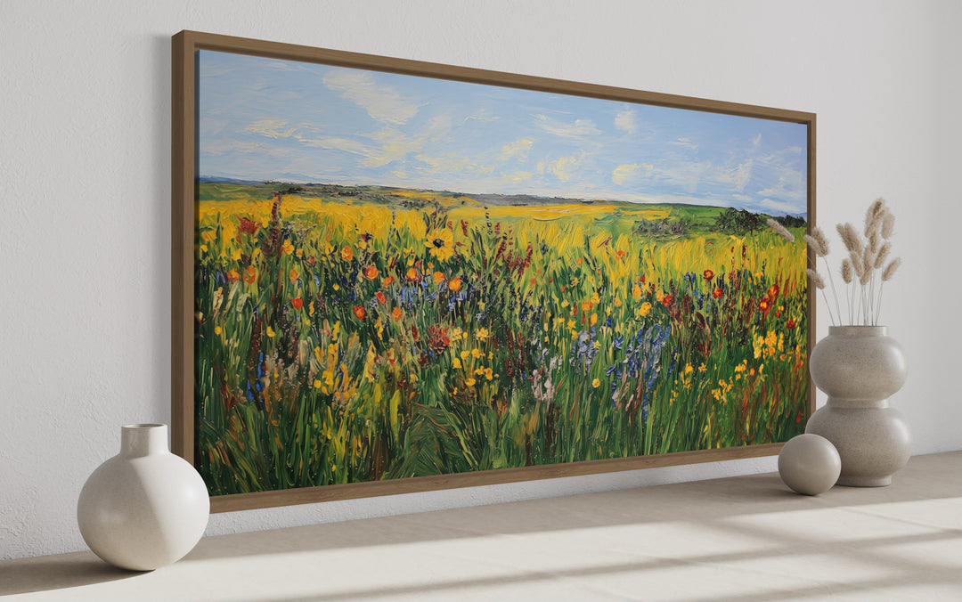 Vibrant impressionist wildflower meadow framed canvas wall art in a modern room setting.
