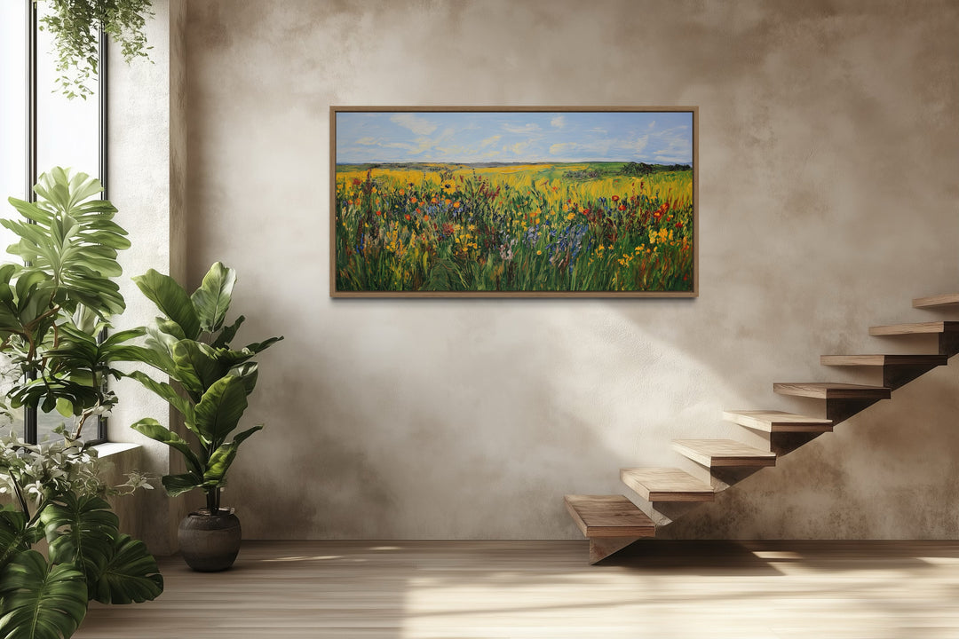 Vibrant impressionist wildflower meadow framed canvas wall art in a modern room with stairs.