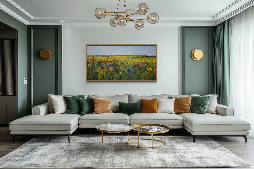 Vibrant impressionist green and yellow wildflower meadow framed canvas art above a modern sofa.