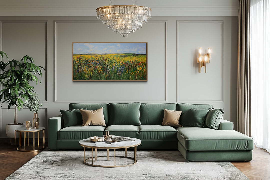 Vibrant impressionist green and yellow wildflower meadow framed canvas wall art above a green sofa.