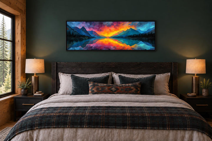 Vibrant mountain lake reflection sunset long horizontal framed canvas wall art above a bed.