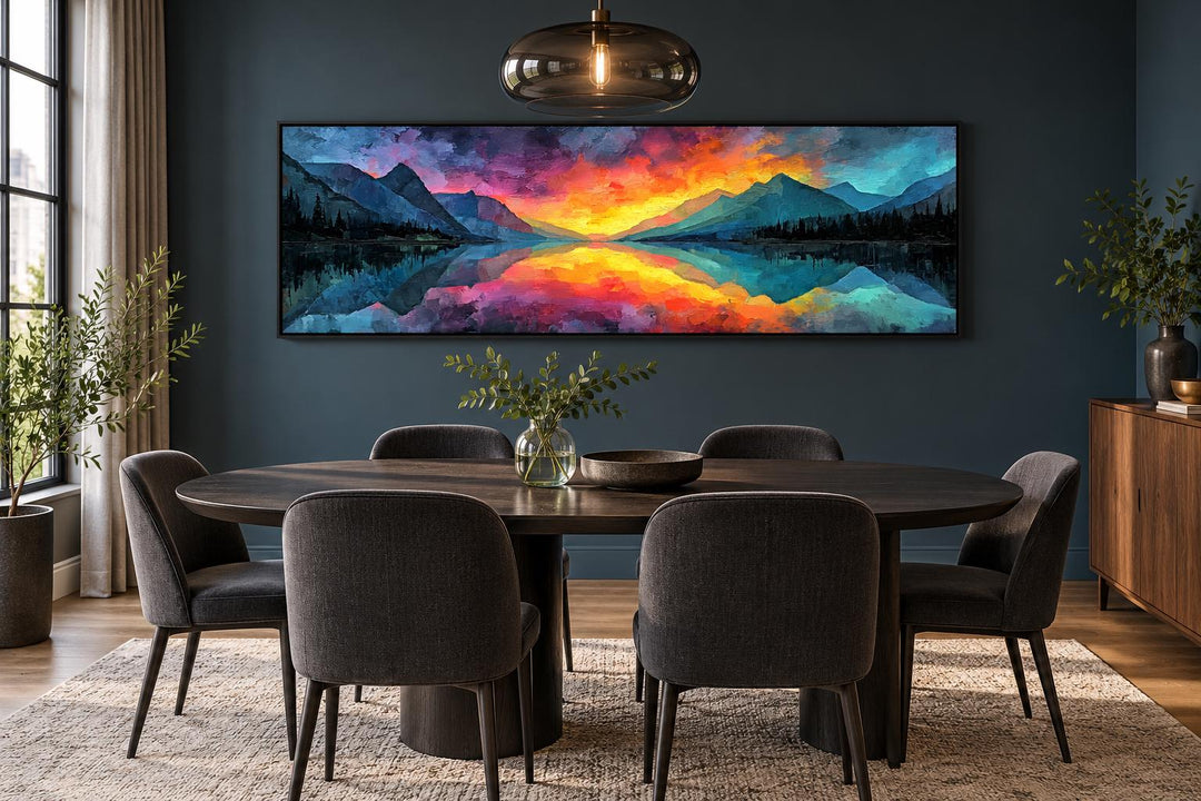 Vibrant mountain lake sunset long horizontal framed canvas wall art above a dining table.