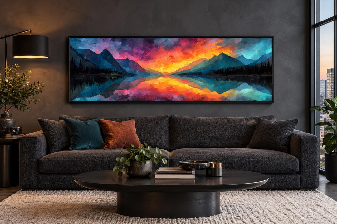 Vibrant mountain lake reflection sunset long horizontal framed canvas wall art above a sofa.