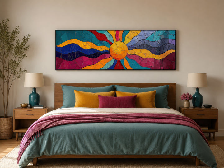 Vibrant multicolored sun long horizontal canvas wall art hanging above a bed in a bedroom.
