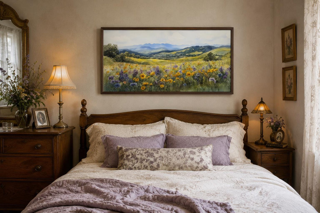 Panoramic watercolor painting of a yellow wildflower field and blue mountains in a wood frame.