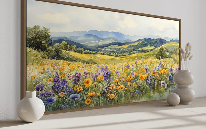 Panoramic watercolor canvas of yellow and purple wildflowers in a field with blue mountains.
