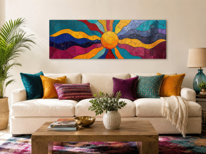 Vibrant multicolored sun long horizontal canvas wall art hanging above a sofa in a living room.