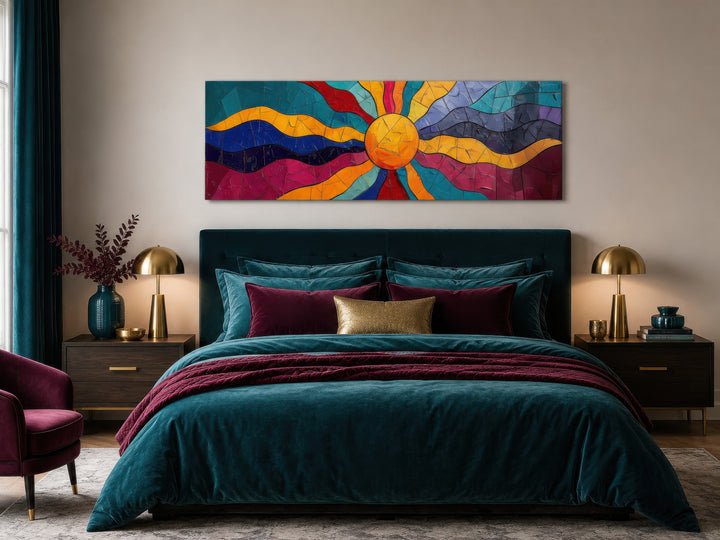 Vibrant multicolored sun long horizontal canvas wall art hanging above a bed in a modern bedroom.