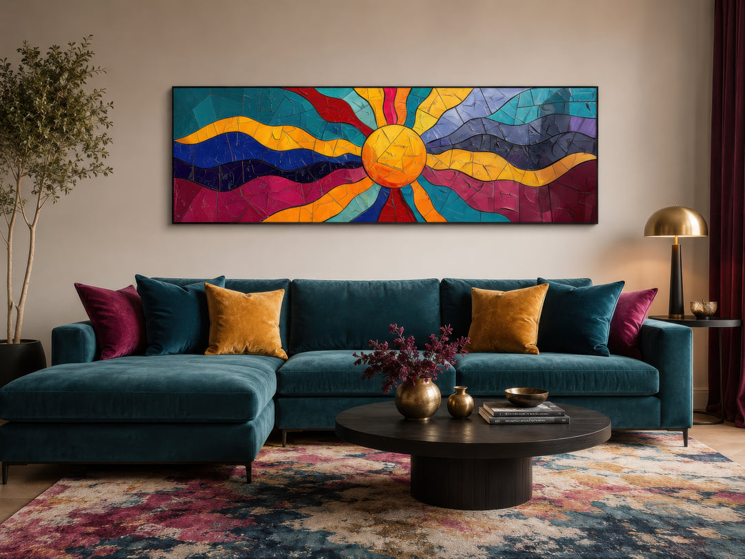 Vibrant multicolored sun long horizontal canvas wall art above a teal sofa in a living room.