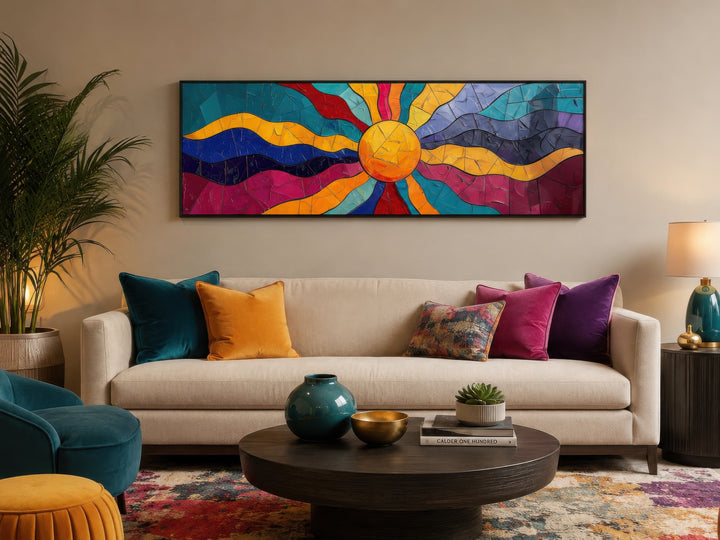 Vibrant multicolored sun horizontal canvas wall art above a beige sofa in a modern living room.