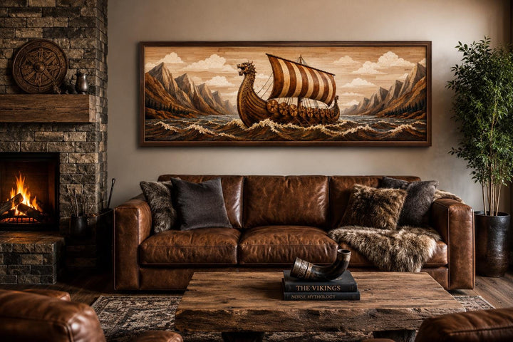 Viking longship canvas print above a leather sofa in a rustic living room with a fireplace.