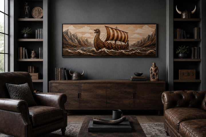Viking longship canvas print on a dark wall above a wooden sideboard in a moody, masculine room.