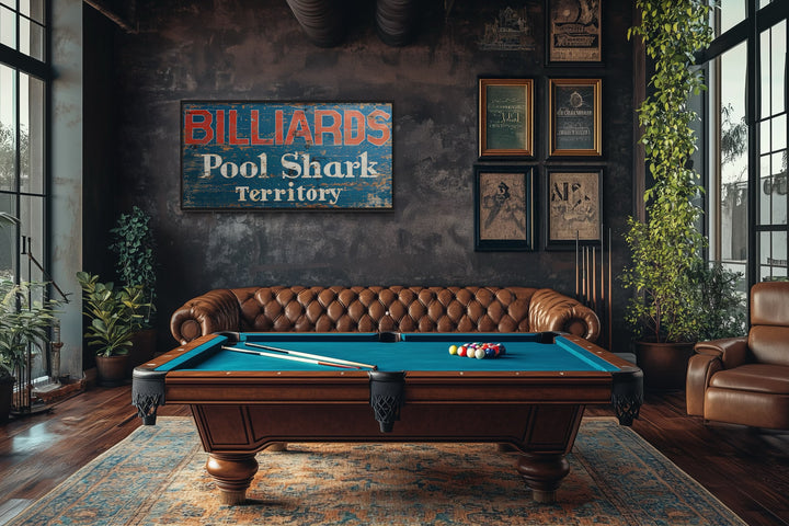 Vintage Billiards Sign with Pool Shark Territory text on a dark wall above a pool table.