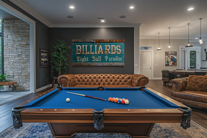 Vintage Billiards Eight Ball Paradise sign on a dark wall above a brown leather sofa and pool table.