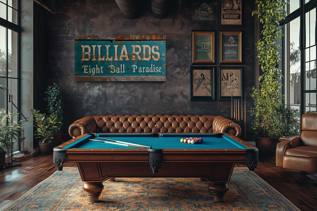 Vintage Billiards Eight Ball Paradise sign on a dark wall above a pool table in a game room.
