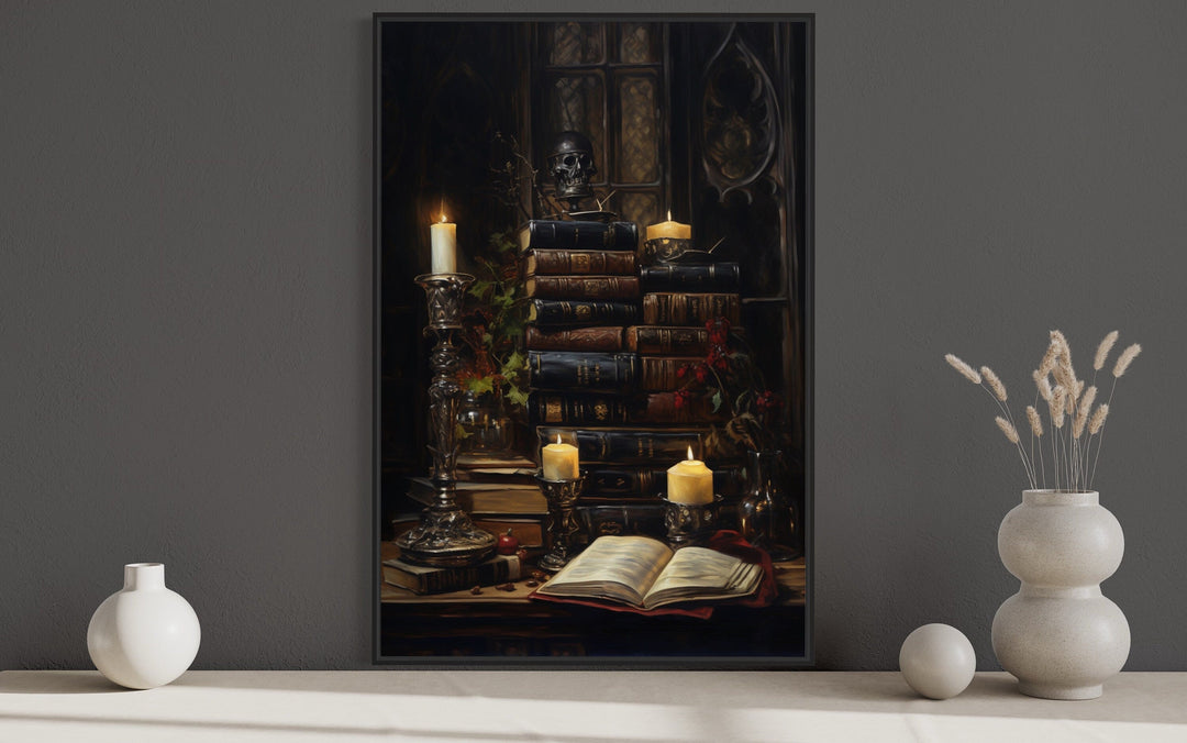 Gothic wall art of vintage books, candles, and a skull in a dark library setting.