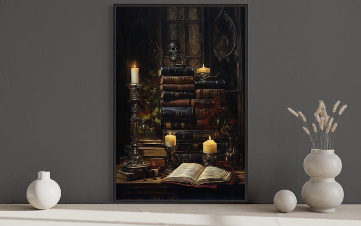 Gothic wall art of vintage books, candles, and a skull in a dark library setting.