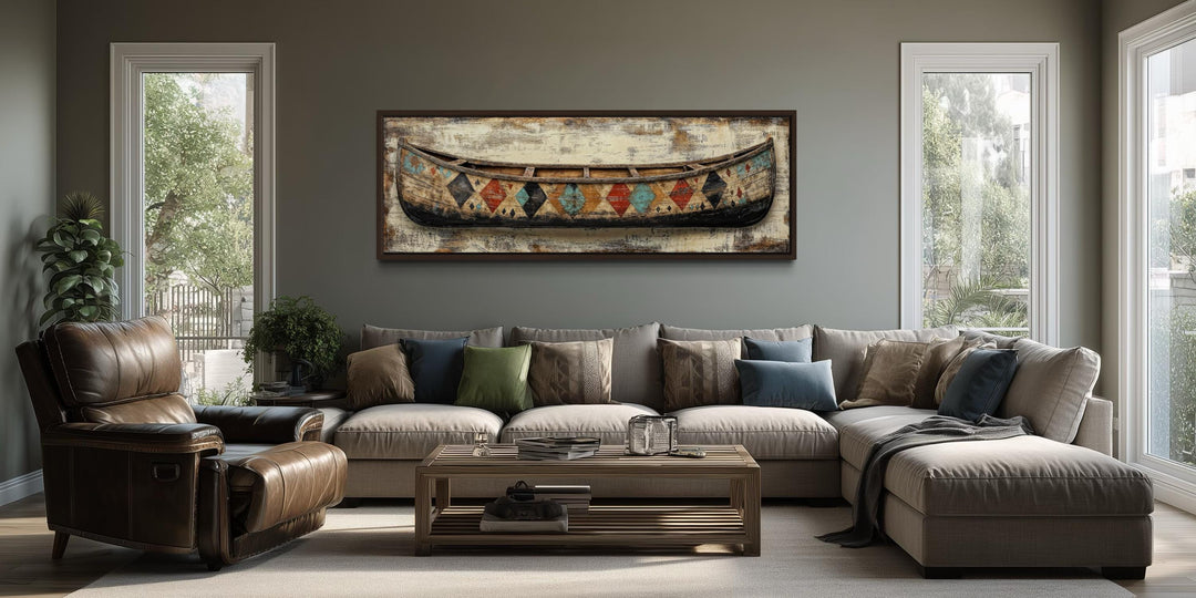 Vintage canoe with Native American patterns on a long horizontal canvas in a modern living room.