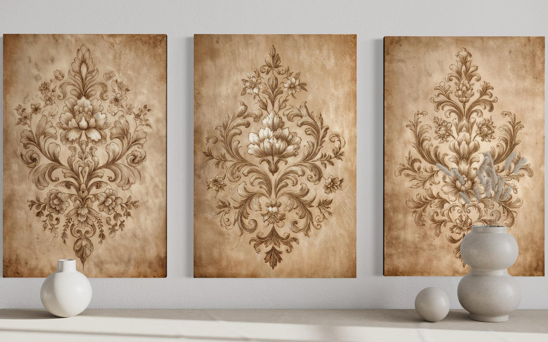 Three vertical canvases featuring intricate vintage damask patterns in neutral beige tones.