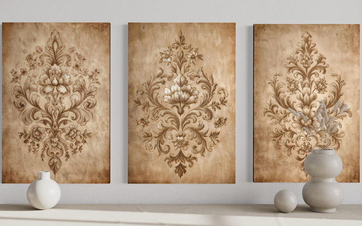 Three vertical canvases featuring intricate vintage damask patterns in neutral beige tones.