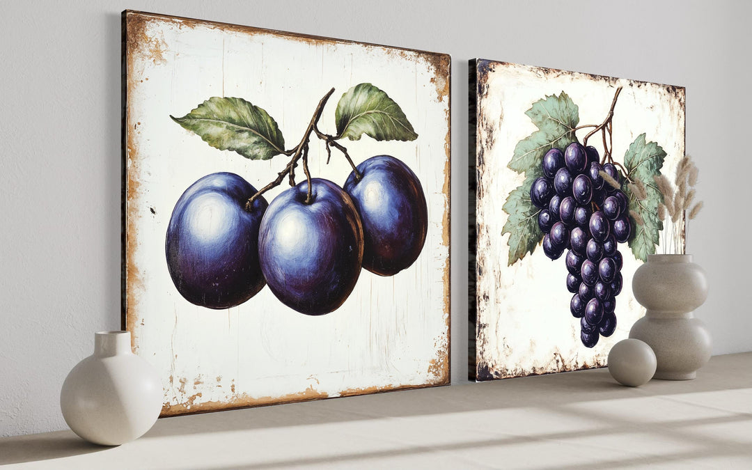 Set of two rustic botanical canvas prints featuring vintage-style plums and grapes.