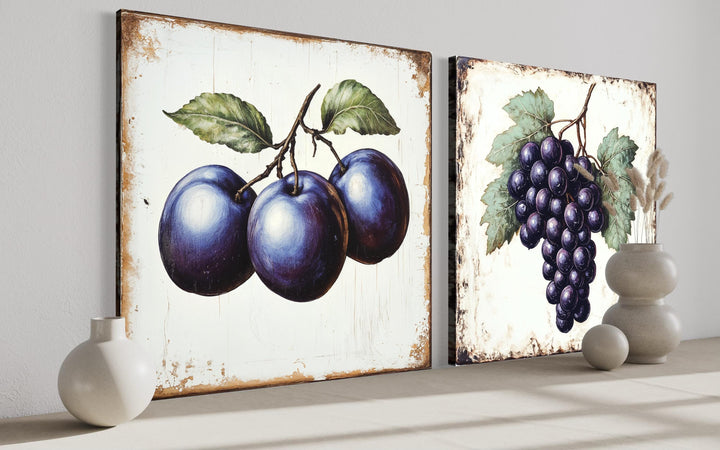 Set of two rustic botanical canvas prints featuring vintage-style plums and grapes.